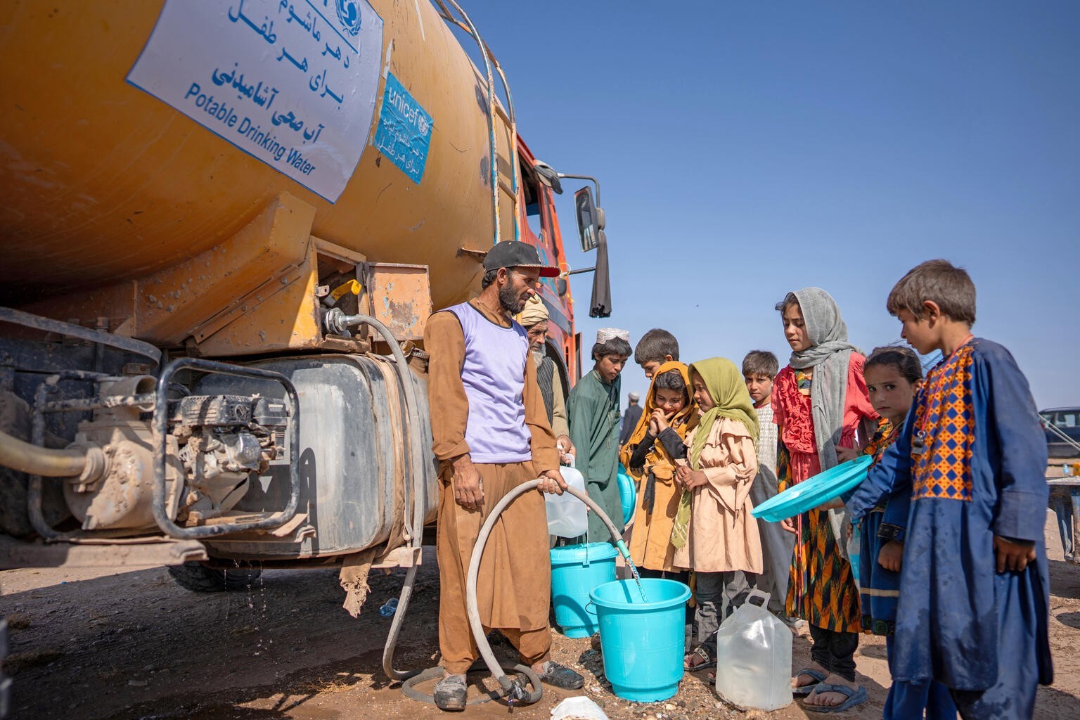 On 11th October 2023, survivors of the recent earthquakes receive safe water from a UNICEF-supported truck in Seyaab, Zinda Jan District, western Afghanistan.