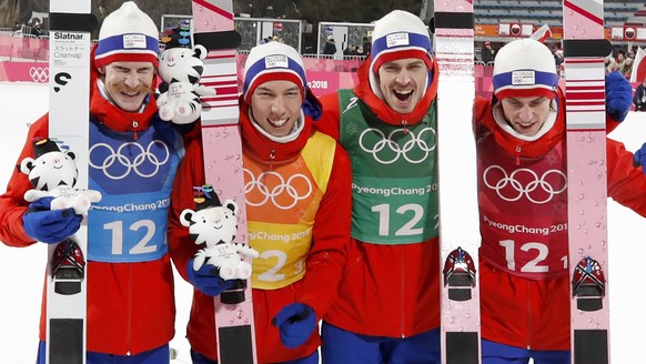epa06543265 (L-R) Robert Johansson, Johann Andre Forfang, Andreas Stjernen and Daniel Andre Tandeof Norway react after winning the gold medal in the Men's Large Hill Team Ski Jumping competition at the Alpensia Ski Jumping Centre during the PyeongChang 2018 Olympic Games, South Korea, 19 February 2018.  EPA/DIEGO AZUBEL