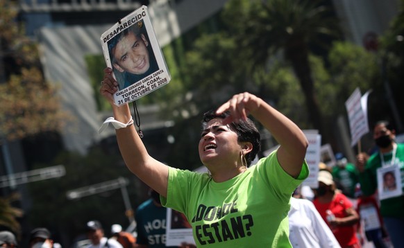 epa09939029 A woman shows a photograph of her loved one who has been missing since 2008 during a large mobilization to demand results and justice, in Mexico City, Mexico, 10 May 2022. Thousands of wom ...