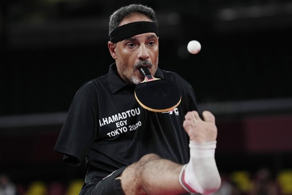 Ibrahim Hamadtou of Egypt flicks the ball with his toes to serves against Park Hong-kyu of South Korea in Class 6, Group E of men&#039;s table tennis at the Tokyo 2020 Paralympic Games Wednesday, Aug. ...