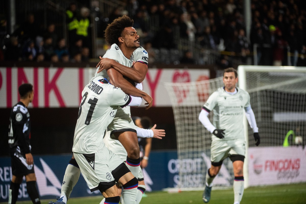Basel's player Renato Veiga center and Dominil Schmid, left, celebrate the 0-1 goal during the Super League soccer match FC Lugano against FC Basel, at the Cornaredo Stadium in Lugano, Wednesday, ...