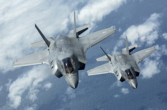 epa05398229 An undated handout picture made available by the British Ministry of Defence (MOD) on 30 June 2016 shows a F-35B Lightning II (L), the first of Britain&#039;s new supersonic &#039;stealth& ...