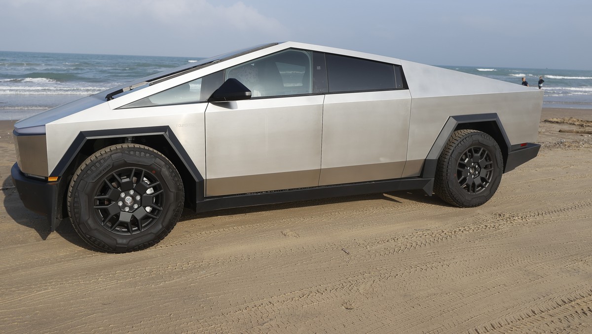epa11219407 A Tesla Cybertruck is parked on the beach near the mega rocket Starship, which wis put in position before a test launch as SpaceX gets ready for their upcoming launch at Starbase in Boca C ...