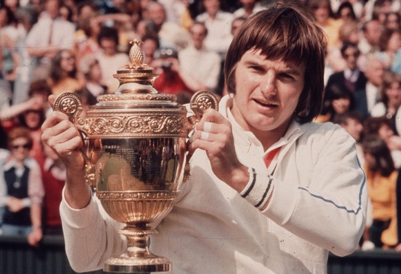 1974: American tennis player Jimmy Connors, holding his trophy after winning the Men's Singles Final at Wimbledon. (Photo by Hulton Archive/Getty Images)