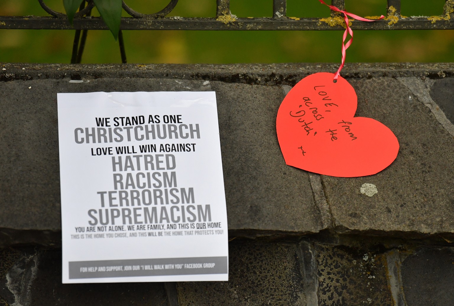 epa07441394 Handwritten notes are visible at a makeshift memorial for the victims of the mosque mass murders at the Botanical Gardens in Christchurch, New Zealand, 16 March 2019. A gunman killed 49 wo ...