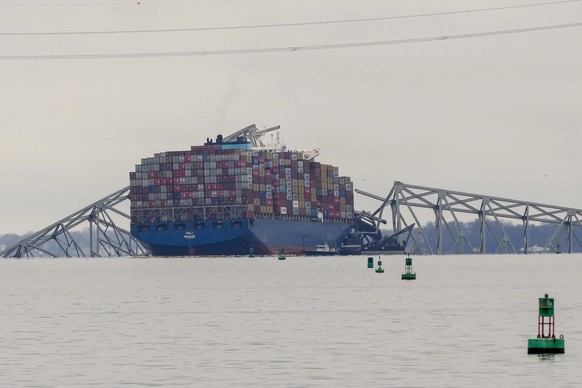 A container ship rests against wreckage of the Francis Scott Key Bridge on Wednesday, March 27, 2024, in Baltimore, Md. The ship rammed into the major bridge early Tuesday, causing it to collapse in a ...