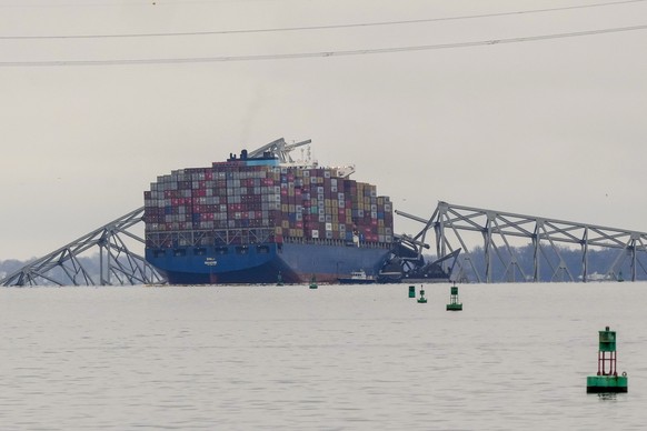 A container ship rests against the wreckage of the Francis Scott Key Bridge on Wednesday, March 27, 2024 in Baltimore, Maryland.  The ship rammed the large bridge early on Tuesday, causing it to collapse into a…
