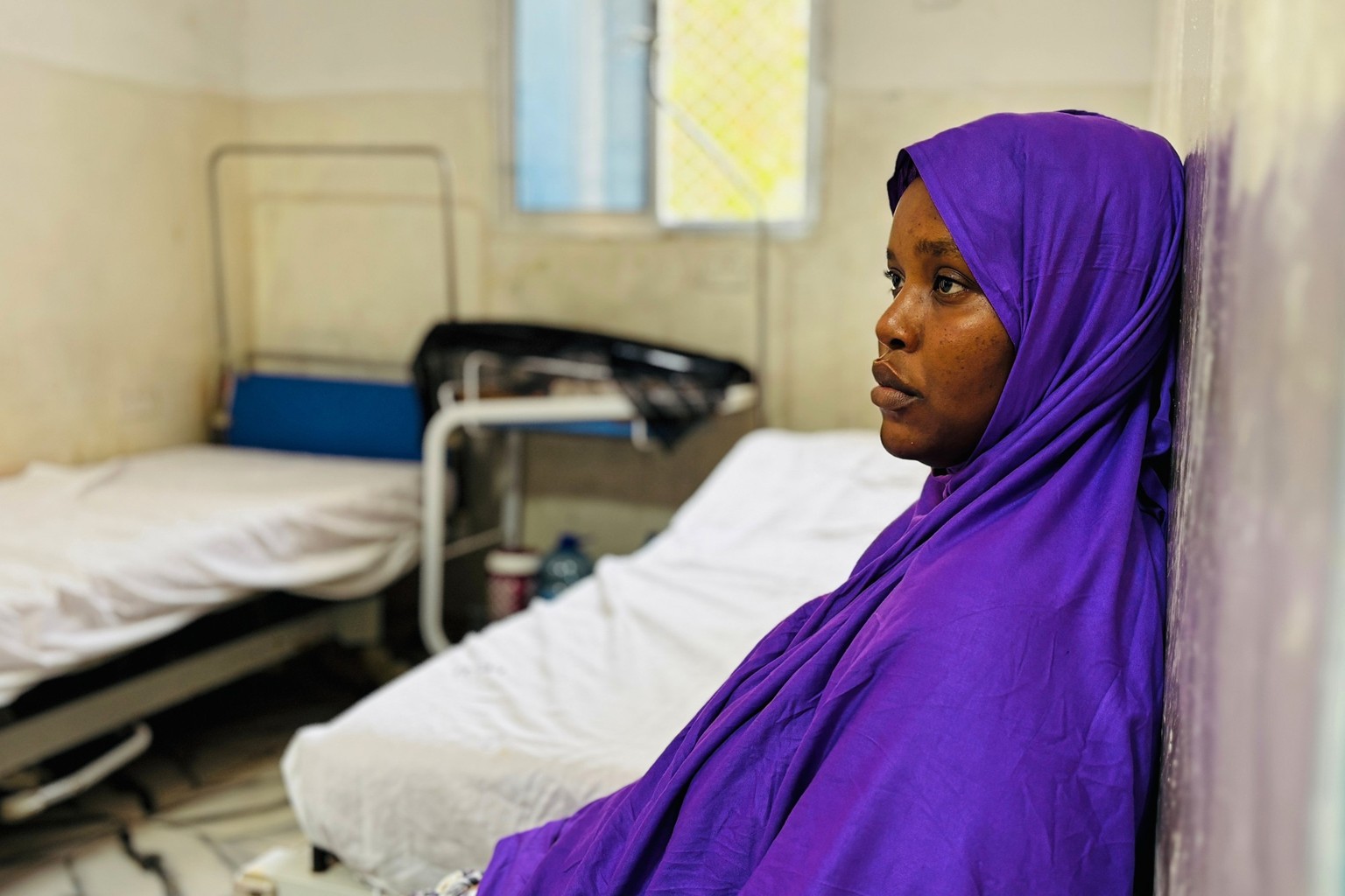 A mother sits in a maternity ward after giving birth, as her baby is in an incubator, background, in Mogadishu, Somalia, Wednesday, Nov. 12, 2025. (AP Photo/Jackson Njehia)