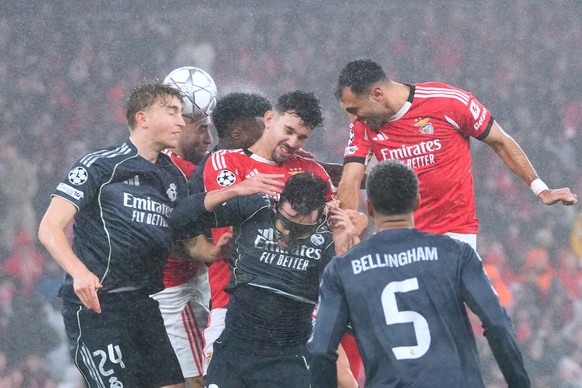 Benfica's Tomas Araujo, center, goes for a header against Real Madrid's Dean Huijsen, left, during a Champions League opening phase soccer match between Benfica and Real Madrid, in Lisbon, W ...