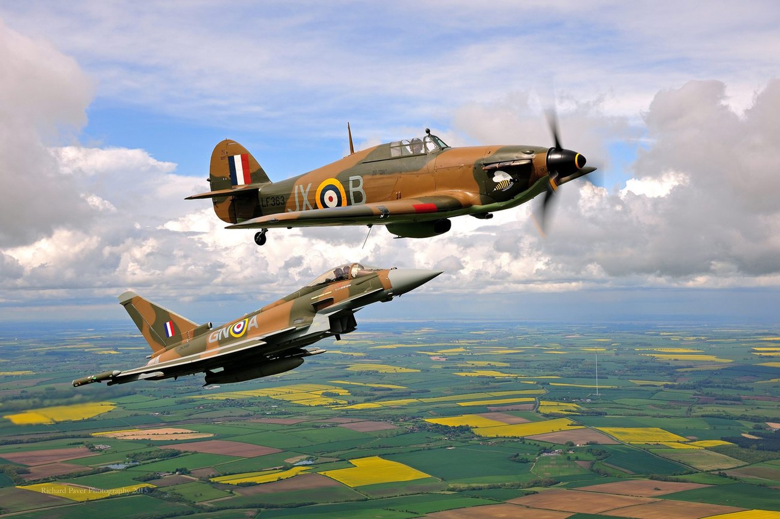 epa04760336 A handout photograph made available on 20 May 2015 by the British Ministry of Defence showing a British Royal Air Force (RAF) Typhoon fighter jet (bottom) in a Battle of Britain era paint  ...