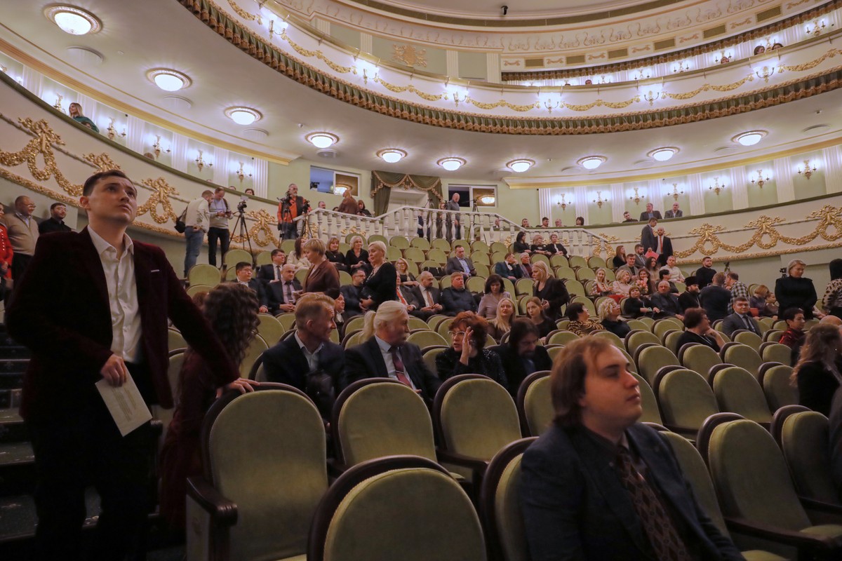 Spectators sit at auditorium of the Mariupol Drama Theatre re-opened its doors for the first time in more than three years, after it was badly damaged during fighting between Russian and Ukrainian for ...