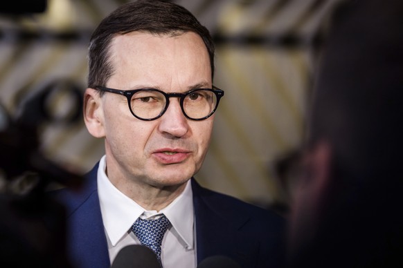 Poland's Prime Minister Mateusz Morawiecki speaks to media before the second day's session of an extraordinary meeting of EU leaders to discuss Ukraine, energy and food security at the Europa building ...