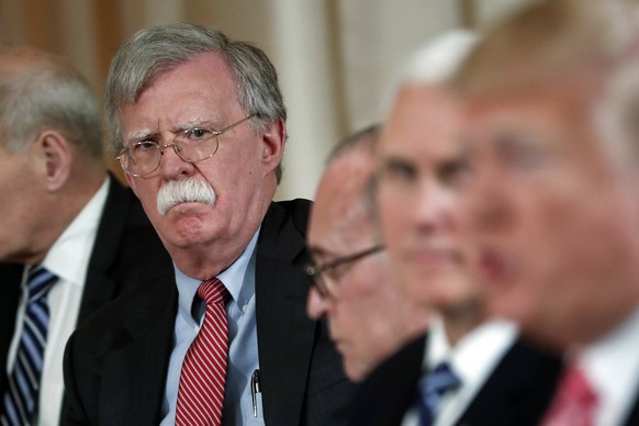 FILE - In this April 18, 2018 file photo, National security adviser John Bolton, left, listens to President Donald Trump, far right, speak during a working lunch with Japanese Prime Minister Shinzo Ab ...