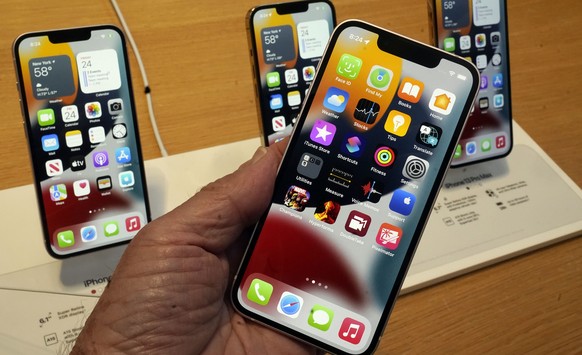 The line-up of the Apple iPhone 13 is displayed on their first day of sale, in New York, Friday, Sept. 24, 2021. They are: iPhone 13 mini, foregroud, iPhone 13, iPhone 13 Pro, and iPhone 13 ProMax, le ...