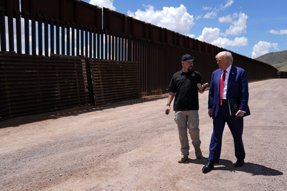 FILE - Republican presidential nominee former President Donald Trump listens to Paul Perez, president of the National Border Patrol Council, as he tours the southern border with Mexico, on Aug. 22, 20 ...