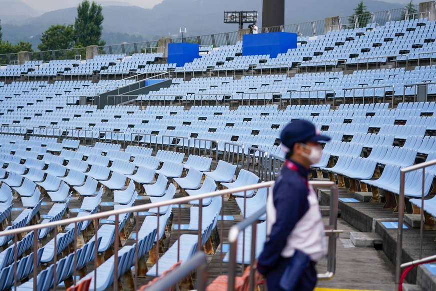 A steward stands in the empty stands at the softball game between the Mexico and Japan at the 2020 Summer Olympics in Fukushima, Japan, July 22, 2021. (AP Photo/Jae C. Hong)