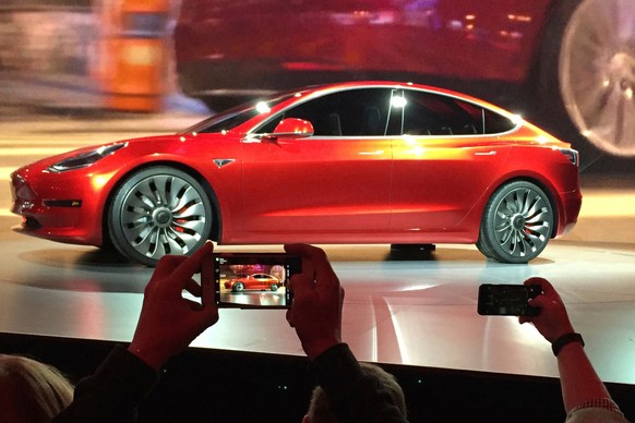 FILE- In this March 31, 2016, file photo, Tesla Motors unveils the new lower-priced Model 3 sedan at the Tesla Motors design studio in Hawthorne, Calif. Long emergency stopping distances, difficult-to ...