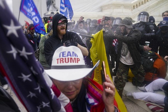 FILE - In this Jan. 6, 2021, file photo, insurrections loyal to President Donald Trump try to break through a police barrier at the Capitol in Washington. First, some blamed the deadly Jan. 6 attack o ...