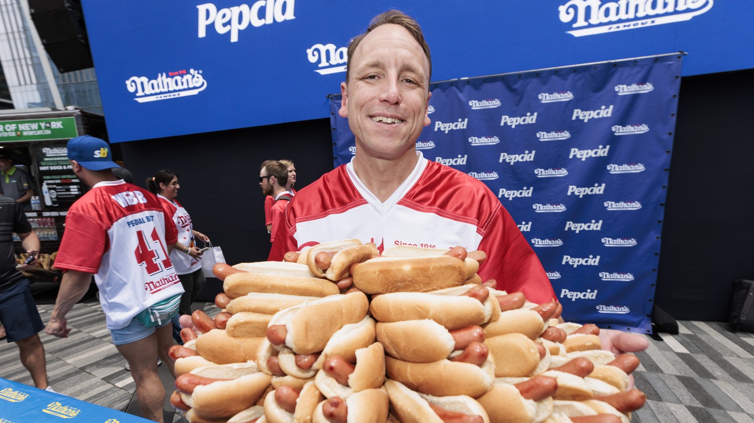 epa10724535 Top-ranked competitive eater Joey Chestnut holds a plate of 76 hot dogs, the record number he has eaten, during a weigh-in ceremony for Nathan&#039;s Famous Fourth of July International Ho ...