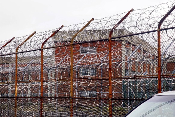 FILE - In this March 16, 2011, file photo, a security fence surrounds inmate housing on the Rikers Island correctional facility in New York. New York City lawmakers are considering a plan to close the ...