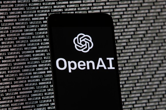 FILE - The OpenAI logo appears on a mobile phone in front of a computer screen with random binary data, March 9, 2023, in Boston. (AP Photo/Michael Dwyer, File)
OpenAI