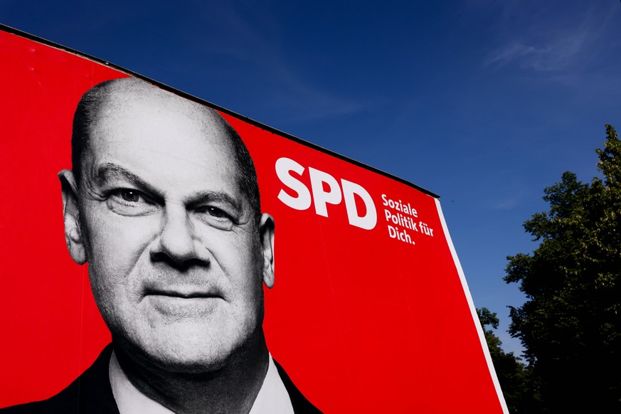 epa09410760 A large scale election poster shows Social Democratic Party (SPD) top candidate for the federal elections, Olaf Scholz, in Berlin, Germany, 12 August 2021. The federal German elections wil ...