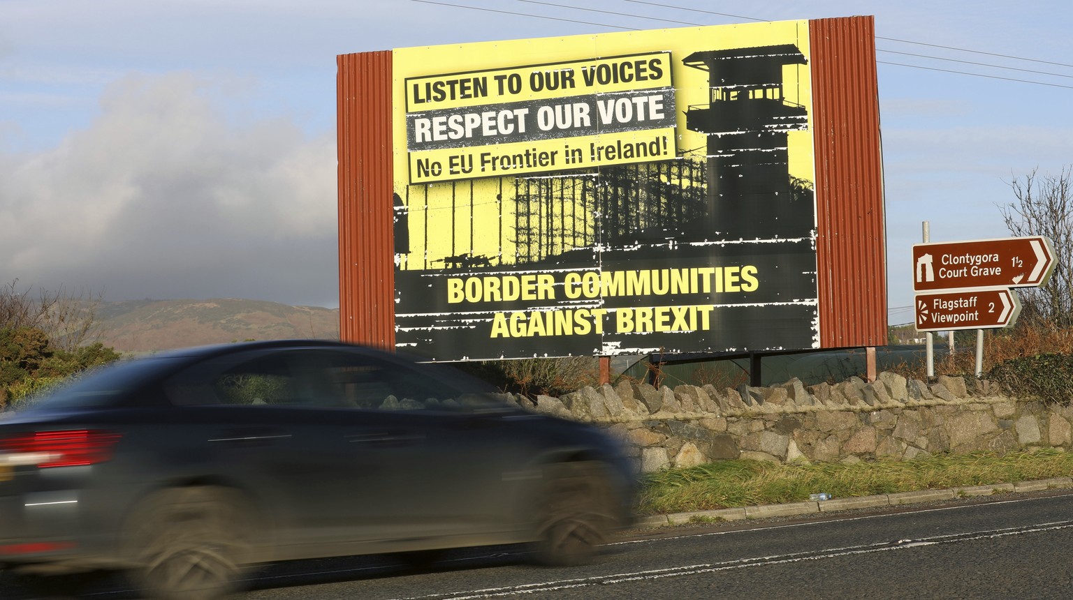 A motorist makes their way North along the old Belfast to Dublin road on the Irish border between Northern Ireland and the Irish Republic close to the town of Newry,, Northern Ireland, Thursday, Nov.  ...