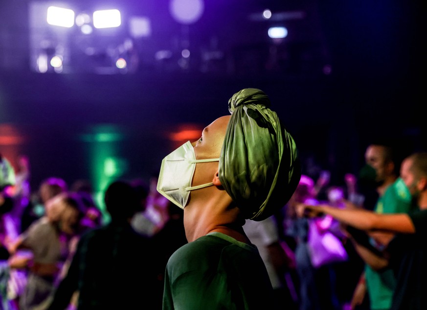 epa09490563 Green party (Alliance 90/The Greens) Member dances at the election party during the Green party (Alliance 90/The Greens) election event in Berlin, Germany, 26 September 2021. About 60 mill ...