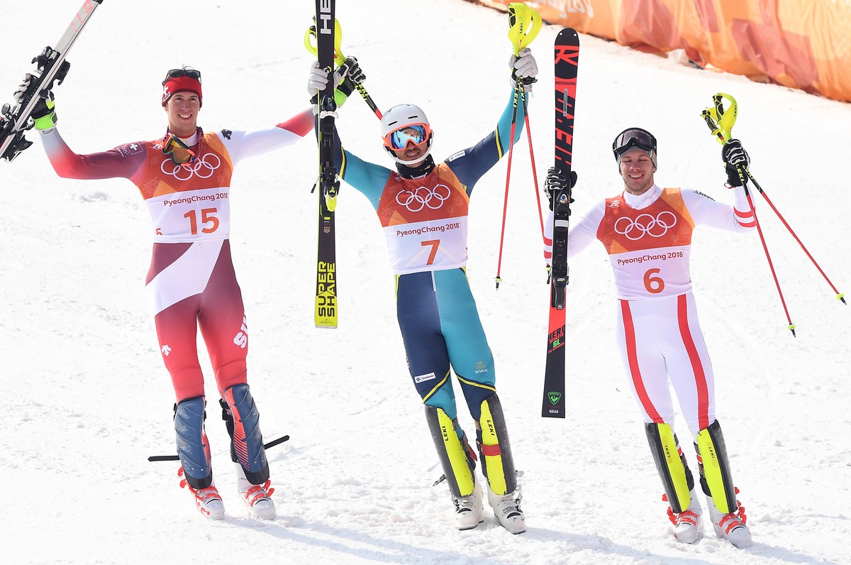 epa06552424 (L-R) Silver medal winner Ramon Zenhaeusern of Switzerland, gold medal winner Andre Myhrer of Sweden and bronze medal winner Michael Matt of Austria react after the Men's Slalom at th ...
