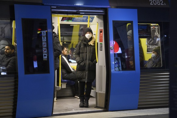 epa08925064 Some passengers onboard an underground train wear masks to curb the spread of the Covid-19 coronavirus, in Stockholm, Sweden, 07 January 2021. The Public Health Agency of Sweden advises pu ...