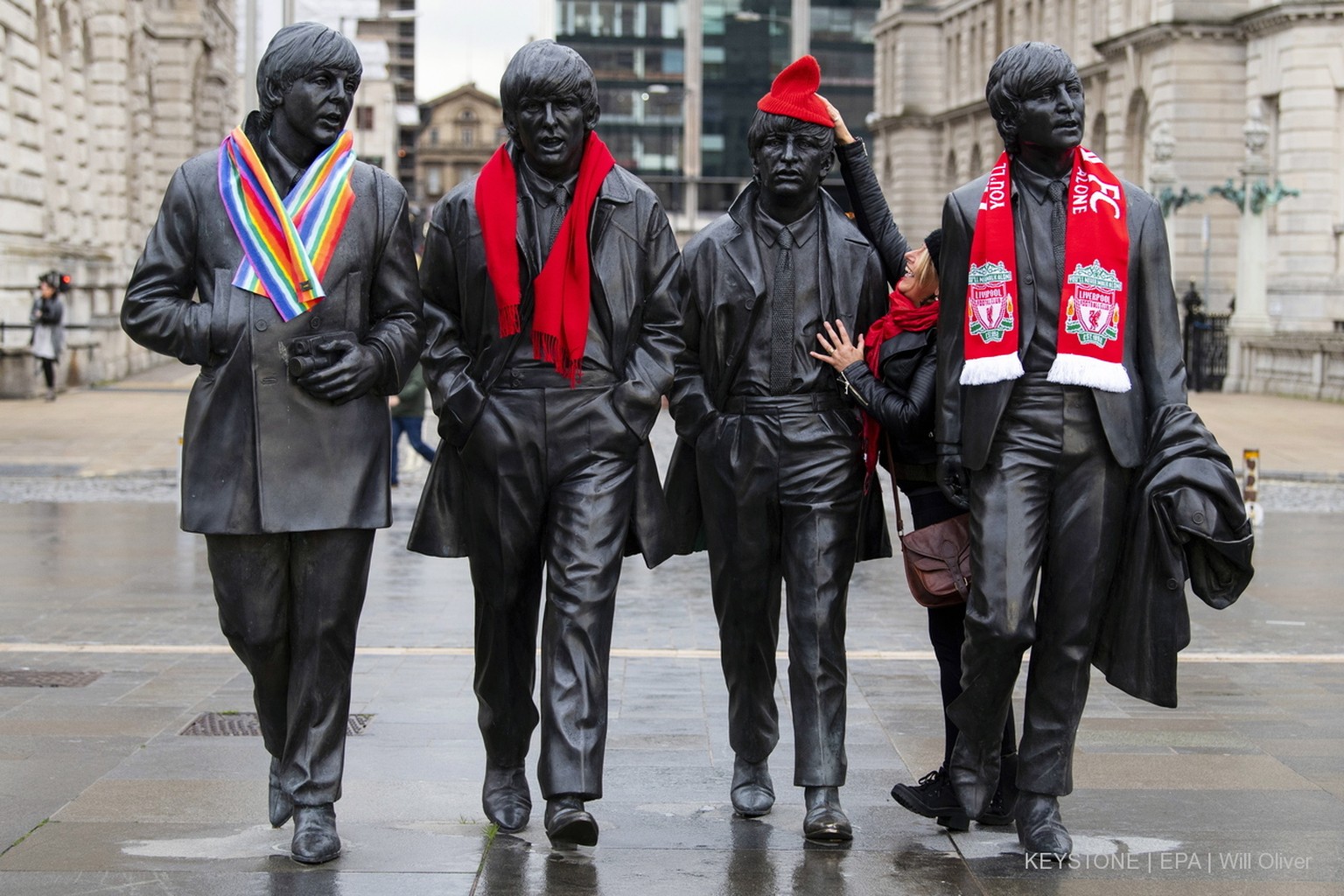 epa07039933 A Labour supporter decorates a statue of the Beatles ahead of the start of the Labour Party Conference in Liverpool, Britain, 22 September 2018. The rally takes place the day before the st ...