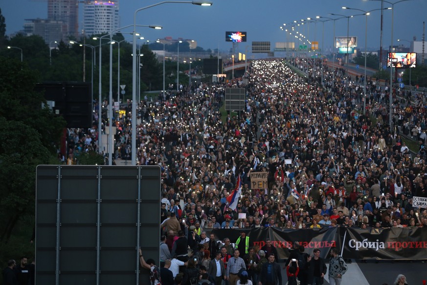 epa10639534 Protesters march on the E-75 highway during a rally against violence in Belgrade, Serbia, 19 May 2023. Opposition political parties have called on a peaceful protest against violence in Se ...