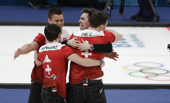 Switzerland's team members celebrate after winning the men's bronze medal curling match against Canada at the 2018 Winter Olympics in Gangneung, South Korea, Friday, Feb. 23, 2018. (AP Photo/Natacha Pisarenko)