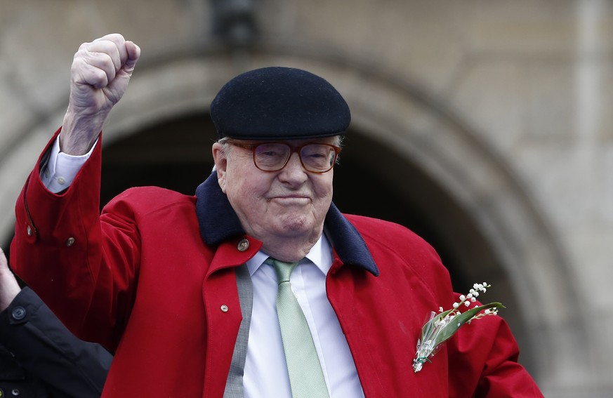 FILE - In this May 1 2017 file photo, former far-right National Front party leader Jean-Marie Le Pen clenches his fist at the statue of Joan of Arc, in Paris. A French appeals court has upheld Friday  ...