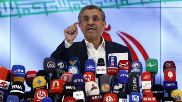 epa11385135 Former Iranian president Mahmoud Ahmadinejad talks to the media after registering his candidacy during the registration for the Iranian presidential election at the interior ministry in Te ...