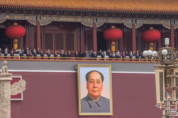 epa09314611 Chinese President Xi Jinping (C) waves above a portrait of fomer leader Mao Zedong from the Forbidden City to the crowd after his speech, at Tiananmen Square during the celebration of 100t ...