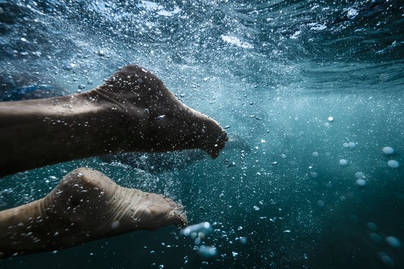 A participant&#039;s feet are seen during the annual Lake Zurich crossing swimming event in Zurich, Switzerland, on Wednesday, August 23, 2023. The participants swam a course across Lake Zurich of 1,5 ...