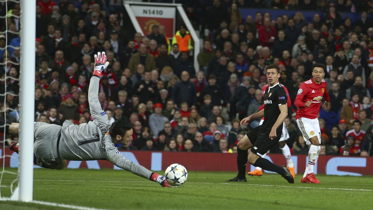 Sevilla's goalkeeper Sergio Rico make a save during the Champions League round of 16 second leg soccer match between Manchester United and Sevilla, at Old Trafford in Manchester, England, Tuesday ...