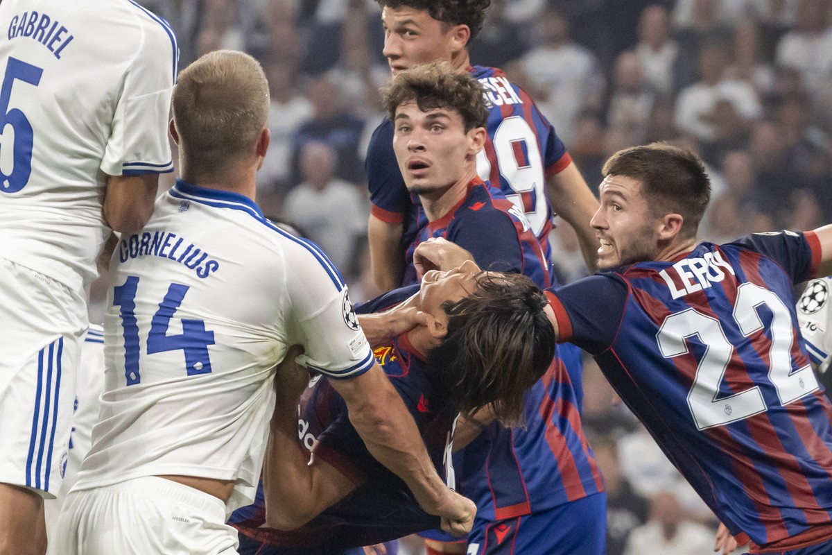 Copenhagen's Andreas Cornelius, left, commits a foul against Basel's Keigo Tsunemoto, from left, without being penalised during the UEFA Champions League play-off second leg match between De ...