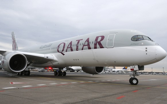 FILE - In this Jan. 15, 2015, file photo, a new Qatar Airways Airbus A350 approaches the gate at the airport in Frankfurt, Germany. Qatar Airways is buying nearly 10 percent of Hong Kong carrier Catha ...
