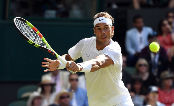 epa07695154 Rafael Nadal of Spain returns to Nick Kyrgios of Australia in their second round match during the Wimbledon Championships at the All England Lawn Tennis Club, in London, Britain, 04 July 2 ...