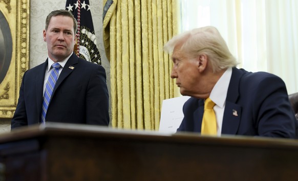 White House national security adviser Mike Waltz listens as President Donald Trump speaks in the Oval Office of the White House in Washington, Friday, March 7, 2025. (Pool via AP)
Trump