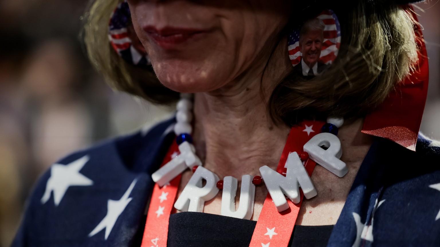 epa11484523 A delegate listens to a speaker during the third day of the Republican National Convention (RNC) at Fiserv Forum in Milwaukee, Wisconsin, USA, 17 July 2024. The convention comes days after ...