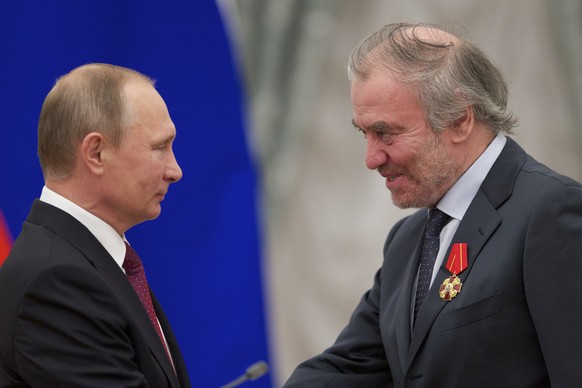 FILE - Russian President Vladimir Putin, left, presents a medal to then Mariinsky Theatre&#039;s Artistic Director Valery Gergiev, during an awarding ceremony in Moscow&#039;s Kremlin, Russia, Thursda ...