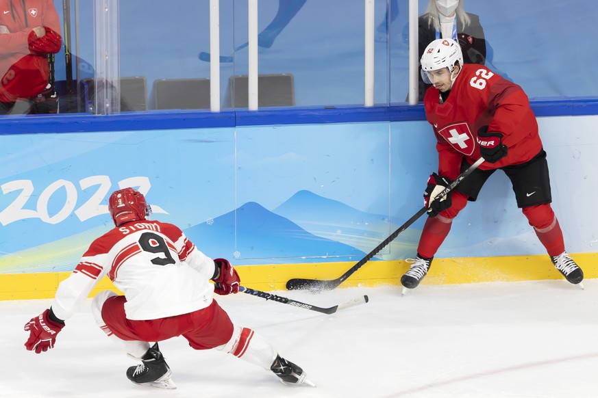 Switzerland&#039;s forward Denis Malgin, right, controls the puck past Denmark&#039;s forward Frederik Storm, left, during the men&#039;s ice hockey preliminary round game between Switzerland and Denm ...