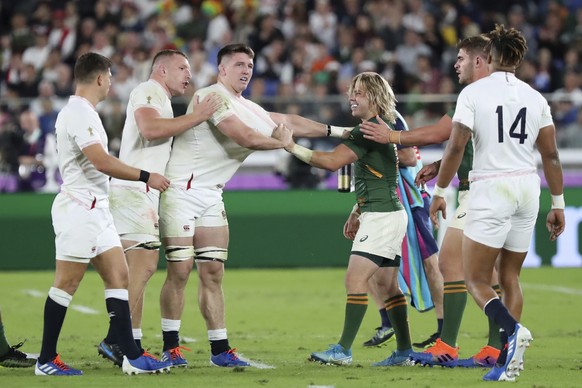 South Africa's Faf de Klerk, center right, and England's Tom Curry, center left, scuffle during the Rugby World Cup final at International Yokohama Stadium in Yokohama, Japan, Saturday, Nov. 2, 2019. (AP Photo/Eugene Hoshiko)