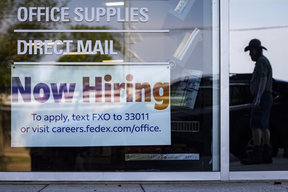 epa10732767 A &#039;now hiring&#039; sign on the window of a FedEx office in Washington, DC, USA, 07 July 2023. According to the Labor department, the US economy added 209,000 jobs in June, far less t ...