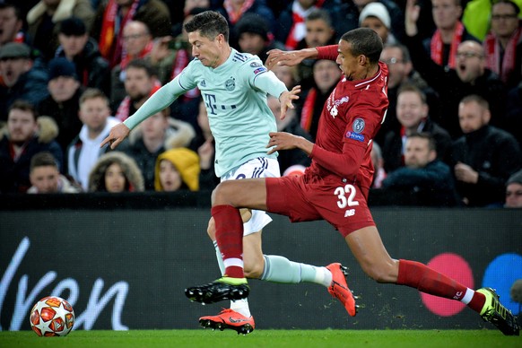 epa07381641 Liverpool&#039;s Joel Matip (R) in action against Bayern&#039;s Robert Lewandowski (L) during the UEFA Champions League round of 16 first leg soccer match between Liverpool FC and FC Bayer ...