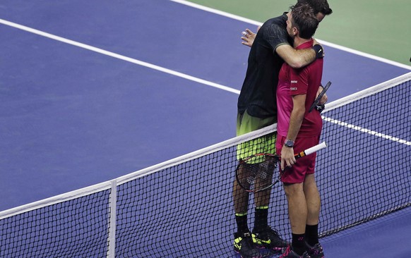 Juan Martin del Potro, left, of Argentina, is embraced by Stan Wawrinka, of Switzerland, after a quarterfinal at the U.S. Open tennis tournament, early Thursday, Sept. 8, 2016, in New York. Wawrinka w ...