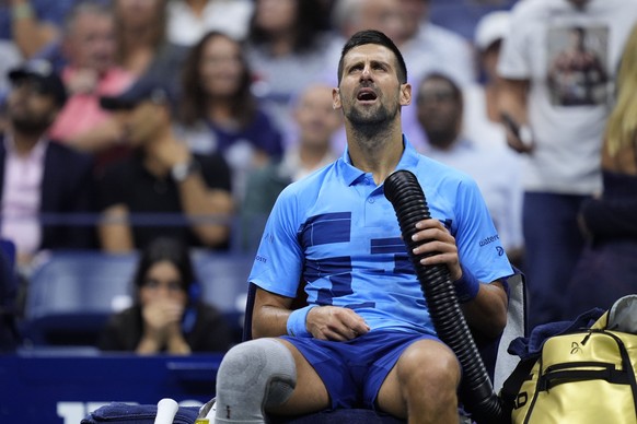 Novak Djokovic, of Serbia, tries to stay cool during a third round match against Alexei Popyrin, of Australia, of the U.S. Open tennis championships, Friday, Aug. 30, 2024, in New York. (AP Photo/Juli ...
